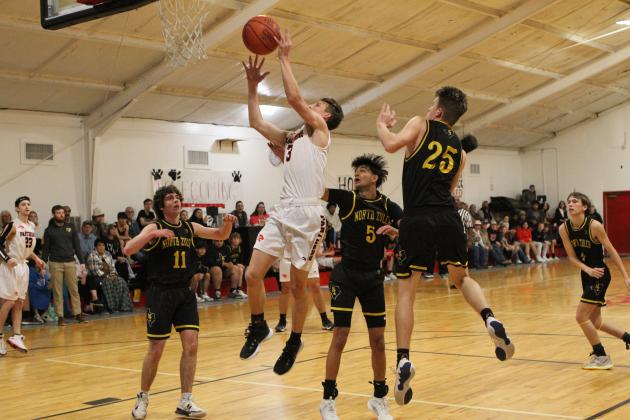Examiner photo by Matthew Ybarra Elijah Bay drives to the basket during homecoming action Jan Article Image Alt Text