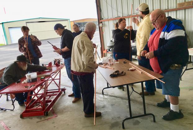 Courtesy photo by Deborah Richardson Cutting, measuring and soldering lengths of copper pipe is needed to create a J-pole antenna, first conceived in 1909 for Zeppelin airships. They would reel them out while in the air and quickly retract them for landing. Their design and portability are why J-poles are still popular. Article Image Alt Text