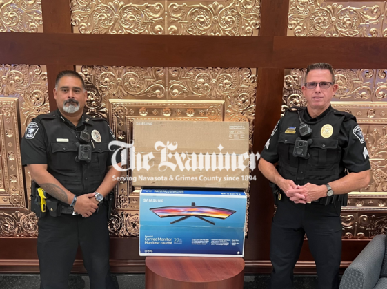 Navasota Police Department received a grant from Walmart to help purchase computer monitors. Displaying some of the proceeds from the grant are Navasota Police Officers Mike Garcia and Troy Green. Courtesy photo Article Image Alt Text