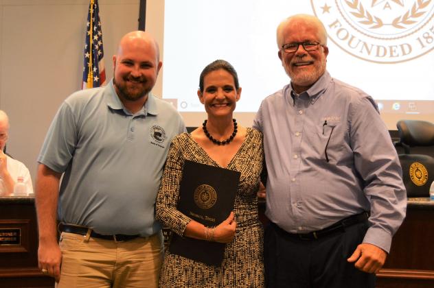 Examiner photo by Connie Clements Mayor Pro-Tem Grant Holt (right) presented Saint Francis Wolf Sanctuary board President Gentry Leonard and Executive Director Nicole Rogers with a certificate of recognition at Monday’s city council meeting in honor of the facility’s ground-breaking in Grimes County. Saint Francis’ mission for 17 years has been to “rescue and provide an exceptional, loving home to non-releasable wolves and wolf-dogs, and to educate the public about these animals.” Article Image Alt Text