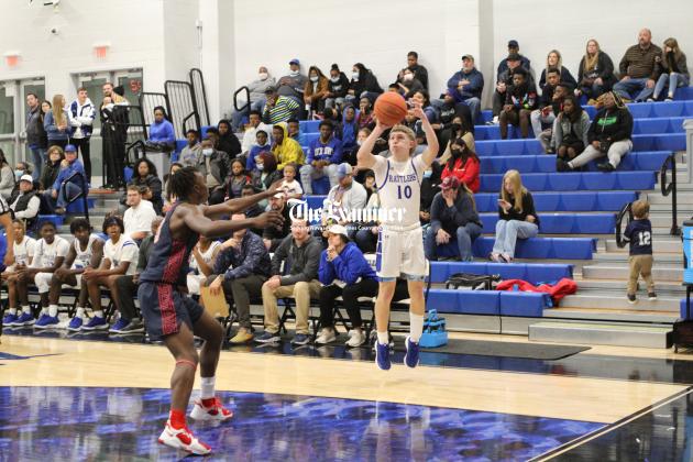 Examiner photo by Matthew Ybarra: John Lee drains a corner-three in the Rattlers one-point loss, 42-41, to Madisonville. He finished with 6 points. Article Image Alt Text