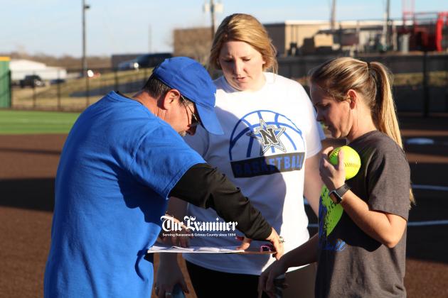 Examiner photo by Matthew Ybarra Doug Harrigan (pictured left) regroups with his coaching staff Kacey Gates (center) and Lisa Marek (right). Harrigan was hired to lead the Lady Rattlers and hosted his first tryouts Friday, Jan. 14, at Ira Floyd Field. Article Image Alt Text