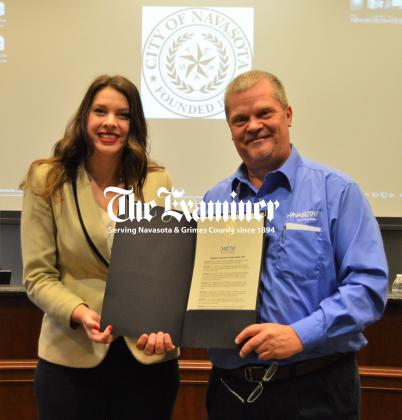 City of Navasota Marketing & Communications Coordinator Bobbie Ullrich accepts a Proclamation from Mayor Bert Miller recognizing National Travel and Tourism Week 2023. The proclamation notes that travel had an economic output of $2.6 trillion dollars in 2022, supported 14.5 million American jobs, generated $84 billion in state and local tax revenue in 2022 and that the recovery of the travel industry is dependent on return of leisure, business and international travel. Article Image Alt Text