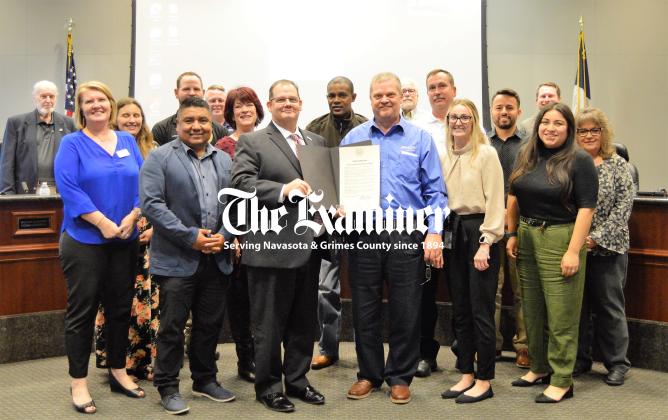 Mayor Bert Miller presents a proclamation for Public Service Week to City Manager Jason Weeks in recognition of the public servants serving at the city, county, state and federal level, community volunteers and the citizens who serve on boards and commissions. Miller is flanked by City employees, council members and board and commission members. Article Image Alt Text