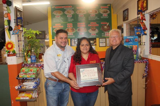 Examiner photo by Ana Cosino La Escondida was awarded the Grimes County Small Business of the Year award at the Small Business Forum held this week. The award is for companies with fewer than 25 employees. They were recognized because of their growth over the past two years and their active community participation. Chamber Executive Director Johnny McNally (right) presents the awrd to owners Javier and Aracely Saenz. Article Image Alt Text