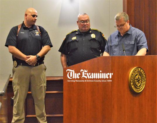 Examiner photo by Connie Clements: Mayor Bert Miller issues a proclamation to the Navasota Police Department recognizing Tuesday, Oct. 5 as National Night Out. NNO events are planned to promote crime and drug prevention awareness and strengthen police-community partnerships to keep neighborhoods safe. Article Image Alt Text